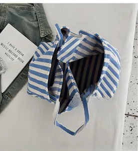 Detailed top view showing internal dual compartments of blue and white striped tote bag