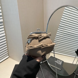 Mini khaki kiss-lock bag with leather bow accents and silver ball chain strap