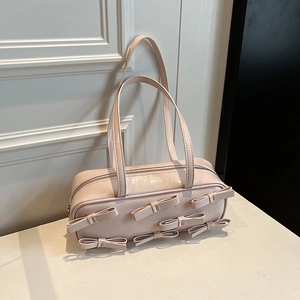 Pale pink glossy ribbon shoulder bag with six bows in a retro barrel design