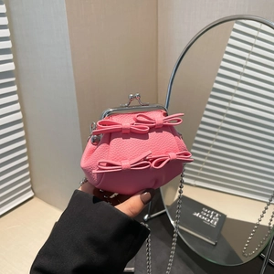 Pink lychee leather mini kiss-lock bag with bow decor and silver chain strap