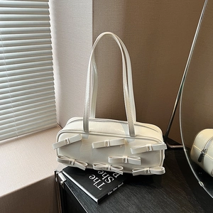 Retro cream white shoulder bag with 3D bow accents and glossy leather finish