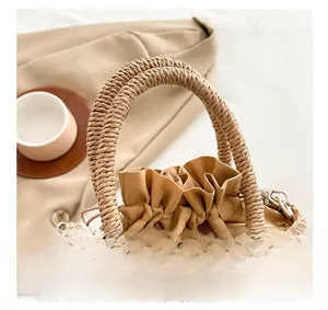 Detail of woven straw handbag featuring wave pattern textures and a drawstring lining