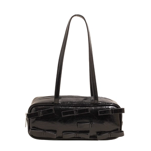 Retro black patent leather shoulder bag with decorative bows and metallic zipper closure
