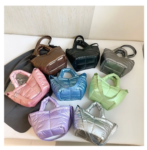 Multiple colors of quilted padded tote bags in metallic nylon with adjustable straps