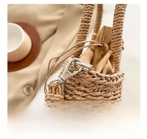 Detail of silver metal lobster clasp and drawstring lining on woven shoulder bag