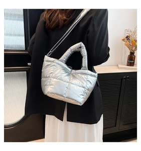 Silver metallic quilted down tote bag with dual handles and adjustable shoulder strap