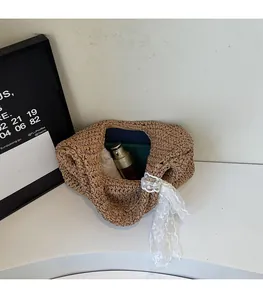 Spacious interior of brown straw bag with white lace ribbon detail and accessories