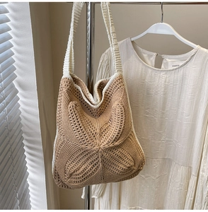 Detail of hand-woven hollow crochet pattern on a large capacity khaki and cream tote bag