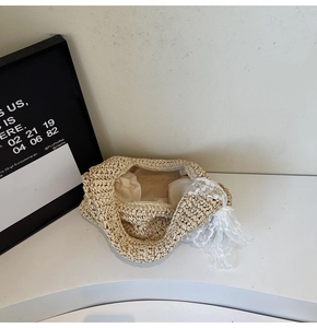 Top view of woven straw beach bag featuring delicate white lace trim and inner lining