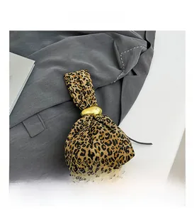 Close-up of leopard print shoulder bag with decorative golden metal ball detail