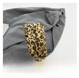 Detail of leopard print handle with gold metal buckle on large capacity shoulder bag