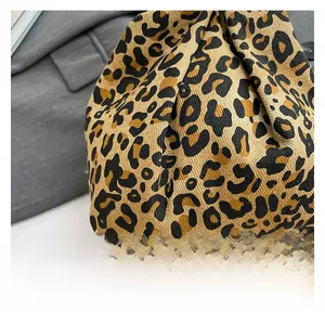 Close-up of premium leopard print knit fabric texture on a large shoulder tote bag