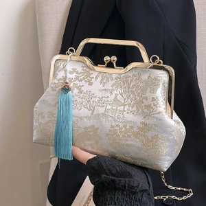 Handheld beige embroidery handbag with golden landscape pattern and blue tassel
