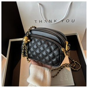 Chic black quilted leather crossbody camera bag with gold chain and spherical buckle detail