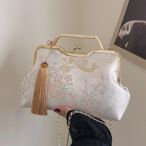 Elegant vintage embroidered qipao handbag with floral silk texture and metal handle