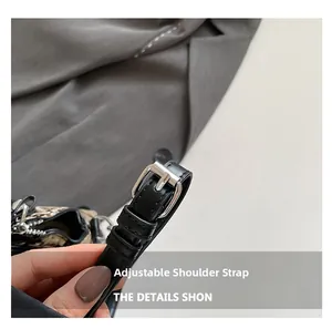 Detail of adjustable black leather strap with silver metal buckle and fine stitching