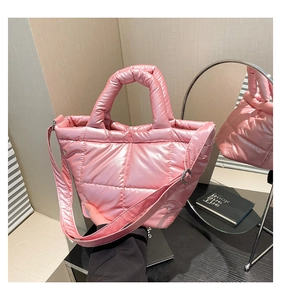 Detailed view of pink quilted puffer tote with glossy finish and adjustable shoulder strap