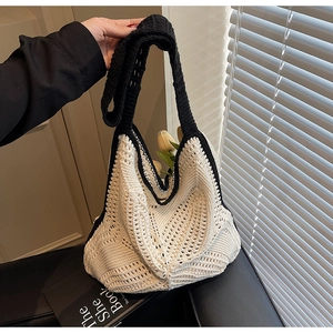 Handcrafted crochet hobo bag with hollow wave pattern and black contrast handle