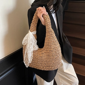 Handmade woven hobo shoulder bag with a white lace bow detail for casual summer style