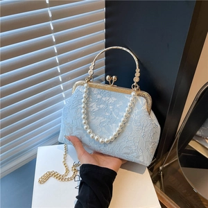 Elegant light blue jacquard floral handbag with pearl handle and golden metal frame