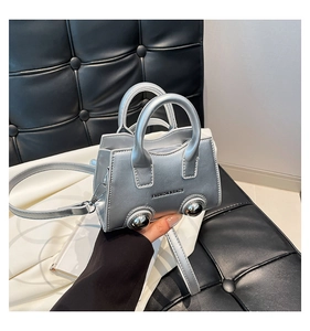 Detail of silver car-shaped mini bag with wheel studs and Fashion & Bags text