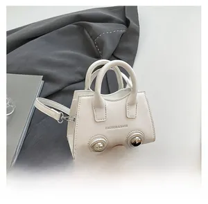 Mini cream motorcycle shell bag charm with fashion logo and slender shoulder strap