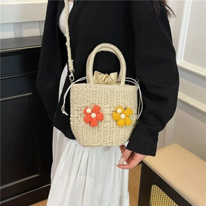 Woven straw crossbody bag with handmade 3D floral accents and top handle for women