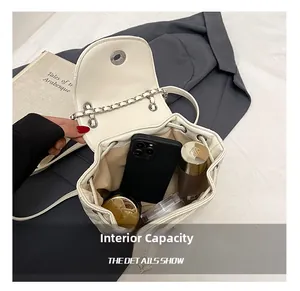 Detailed interior view of white quilted drawstring backpack showing large storage capacity