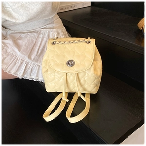 Detail of cream mini backpack with heart quilting, metal twist lock and chain handle