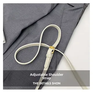 Close-up of white lychee leather adjustable strap with gold buckle detail