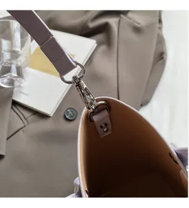 Close-up of premium silver hardware hook on a lavender leather bucket bag