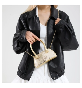 Mini gold sequin shell bag with metal ring handle and bead chain strap on model