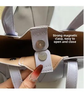 Macro detail of lavender bucket bag showing secure magnetic closure and brown interior lining