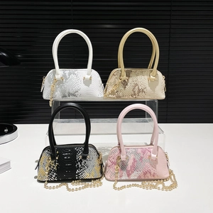 Mini snakeskin shell bags in white, gold, black, and pink with stylish chain handles