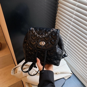 Mini black backpack featuring heart-shaped quilting and silver chain strap details