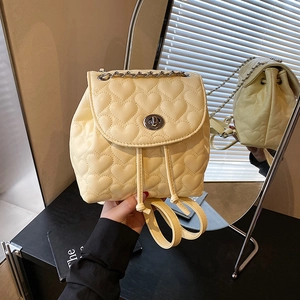 Mini cream backpack with heart quilting and silver turn-lock shown from multiple angles
