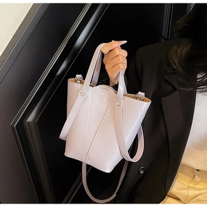 Lilac bucket bag with smooth leather finish, styled on a model for daily commute