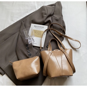 Detail of caramel brown bucket bag set with inner pouch and adjustable metal buckle