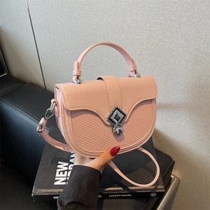 Sacoche rose avec rabat tressé et fermoir métallique pour un style élégant croisé
