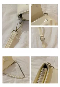 Detail of cream white bag featuring a magnetic buckle, pearl chain, and metal zipper
