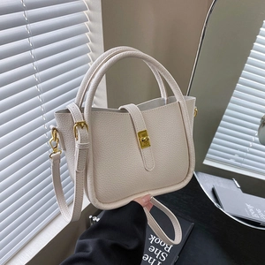Elegant off-white lychee texture leather bucket bag with golden buckle and shoulder strap