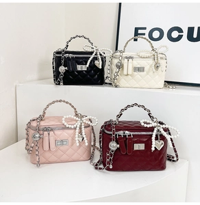 Quilted handbags with chain handles and pearl bow charms in black, cream, pink, and wine red