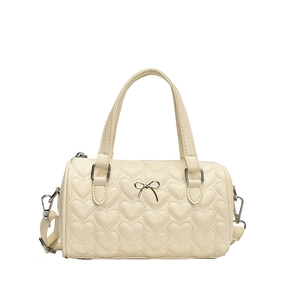 Sac cylindre beige avec matelassage cœur, nœud argenté et bandoulière réglable