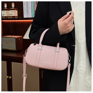 Close-up of pink lychee grain leather handbag with silver zipper and brand text detail