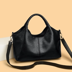 Classic black leather tote bag with vertical stitching and detachable wide shoulder strap