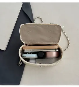 Internal view of quilted chain bag showing space for phone and cosmetics