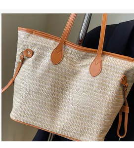 Detail of woven tote bag showing beige straw texture and brown leather trim with rivets