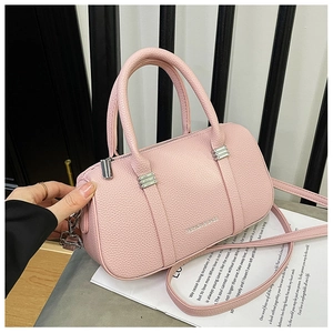 Detail of pink lychee leather Boston bag with silver Fashion & Bags embossed lettering