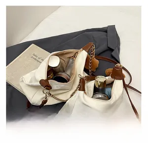 Detail view of white leather tote interior with spacious storage for cosmetics
