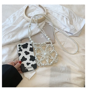 Exquisite handmade white pearl woven flower bag with a stylish cow grain phone case accessory